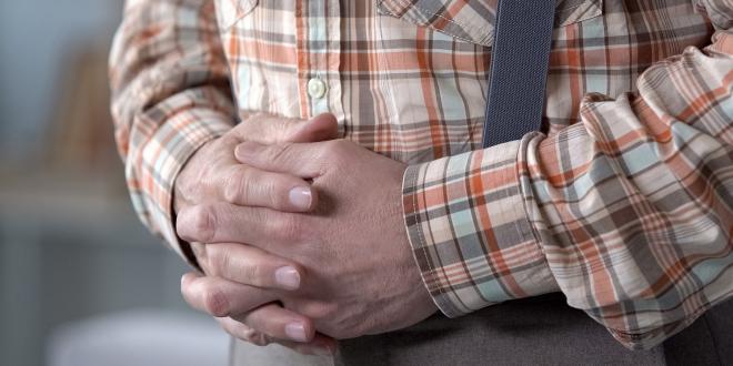 a man holding his gut in pain from a hernia